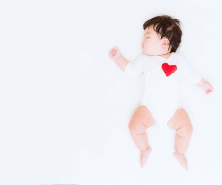 Adorable asian baby girl with heart and copy space for valentine concept background. (Vintage tone)の写真素材