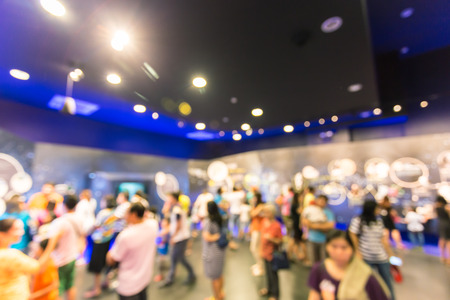 Blurred people walking in the exhibition hall.