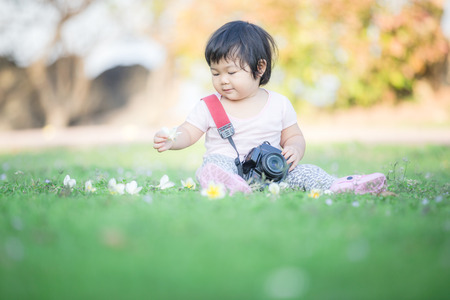 Adorable baby playing and fun on the ground. Suitable use for Child development concept background.の写真素材