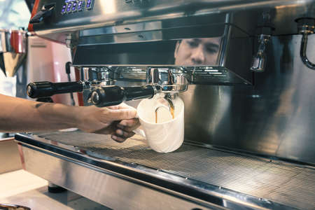 Barista made drink by coffee machine with vintage tone.の写真素材