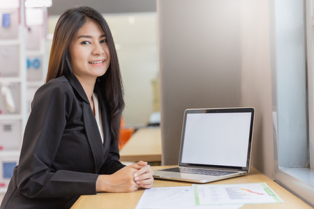 Business woman working in modern office with computer laptop and document for background.の写真素材