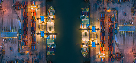 Aerial top view of ship containers at shipping port for international import or export logistics or...