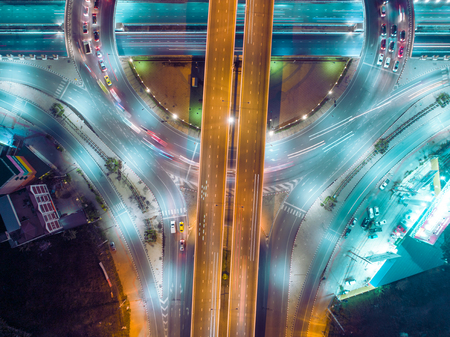 Aerial view highway road intersection at night for transportation, distribution or traffic...