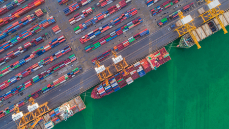 Aerial view container ship and warehouse from sea port for delivery containers shipment. Suitable use for transport or import export to global logistics concept.の写真素材