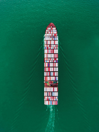Aerial top view container ship on the sea full load container for import export, shipping or transportation.の写真素材