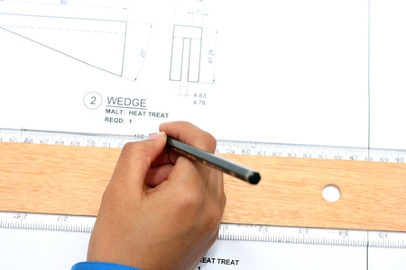 Hand with technical drawing and toolsの写真素材