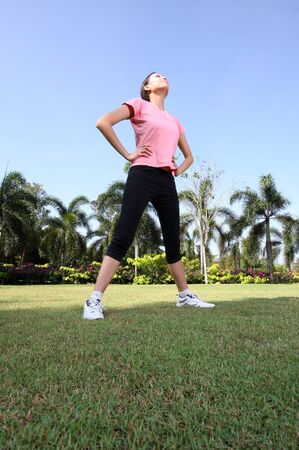 Pretty woman breathing in a park with outdoor exerciseの写真素材