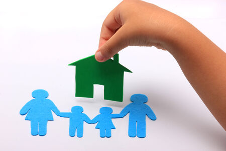 hand with family icon and green houseの写真素材