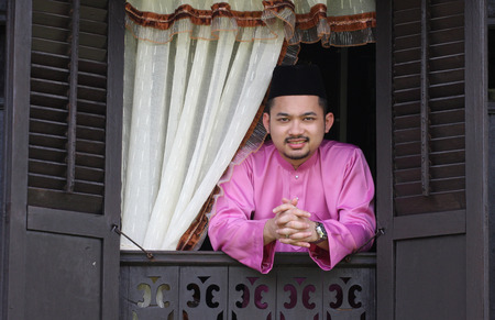 Malay muslim man at  traditional window houseの写真素材