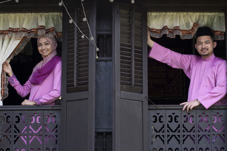 Malay muslim couple with greeting hari raya.の写真素材