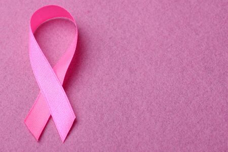 Pink ribbon on pink background. Breast cancer awareness conceptの写真素材