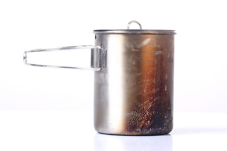Steel camping pot with lid and handle isolated on white backgroundの写真素材