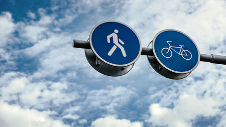 Road signs on the background of the sky with clouds