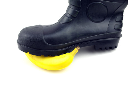 Black rubber boots with bananaの写真素材