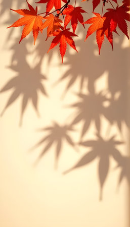 Maple leaves with shadows across beige backdrop, autumn fall conceptの素材