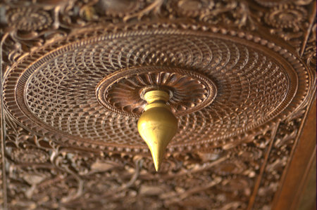 Close up of an antique brass chandelier in a temple.の写真素材