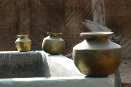 Antique brass vases in an old farmhouse, India.の写真素材
