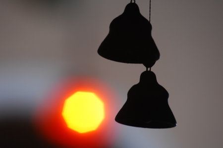 Silhouette of a bell on the background of the setting sunの写真素材