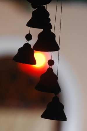 Close up of bells on a blurred background with the setting sun.の写真素材