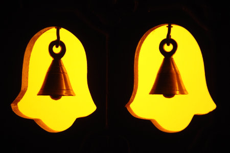 Two bells in the shape of a bell on a black background.の写真素材