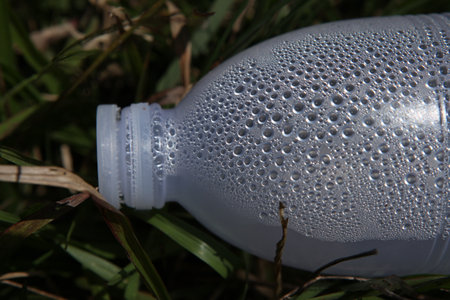 Plastic bottle of water on the grass. Close-up.の写真素材