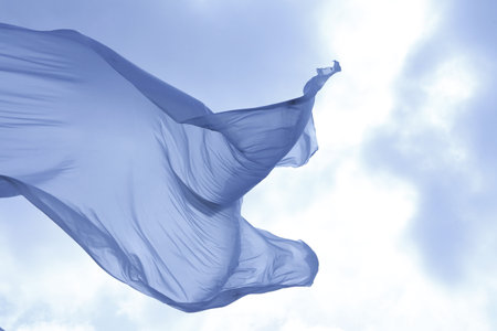 Cloth waving in the blue sky, closeup of photo.の写真素材