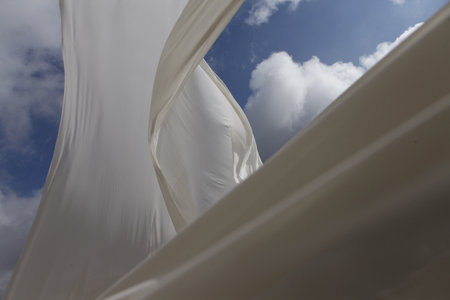 white fabric in the wind on blue sky background, close-upの写真素材
