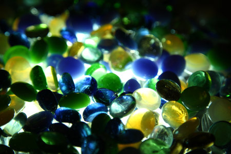 multicolored glass pebbles on a dark background close up