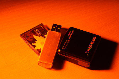 Usb flash drive and credit card on orange background. Selective focus.の写真素材
