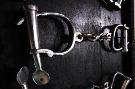 Handcuffs on a dark wooden background. Close-up.の写真素材