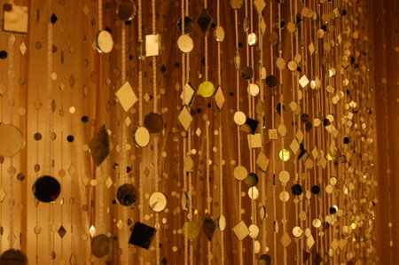 Decorative garland of gold and black sequins on the wall