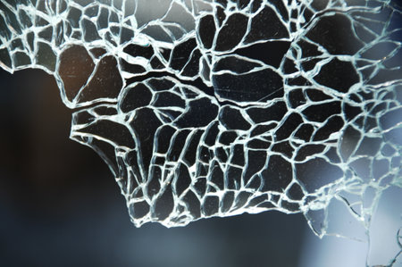 Broken glass as a background. Texture of broken glass with cracksの写真素材