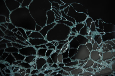 Broken glass on a black background. Close-up image.