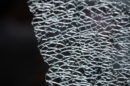 Broken glass on a black background, close-up, macro