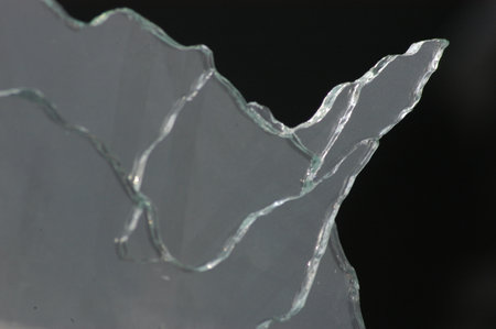 Broken glass on a black background, close-up, macro