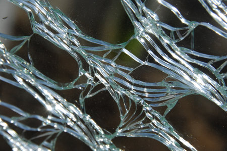 Broken glass on a background of blue sky, close-up