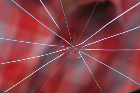 broken glass on a red background, close-up of broken glass