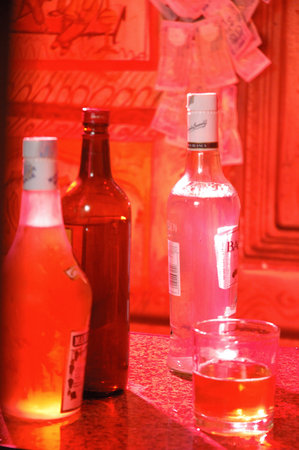 Red wine bottles and glasses on the counter of a restaurant.の写真素材