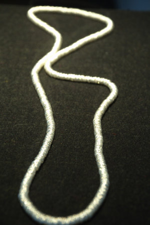 white rope on a black background, close-up, vertical photo
