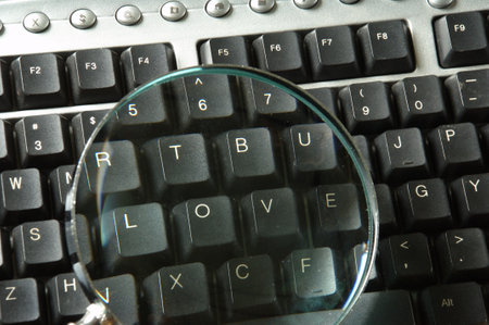 Keyboard with magnifying glass, closeup. Business concept.の写真素材
