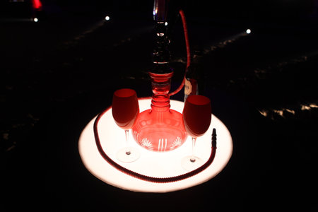 Red hookah on a black background, close-up of photo