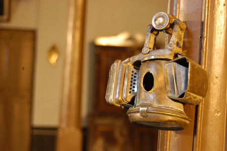 Old oil lamp on a wooden door. Selective focus. Shallow DOF.