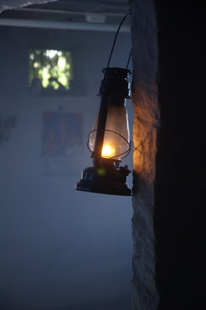 Lantern on a wall in a dark room with fog.の写真素材