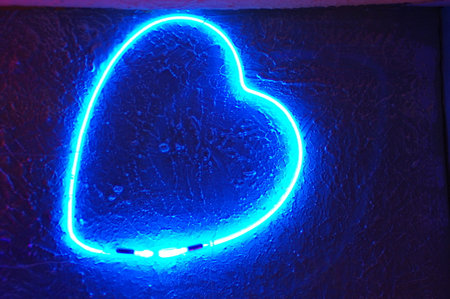 blue neon heart on the wall, valentine's day backgroundの写真素材