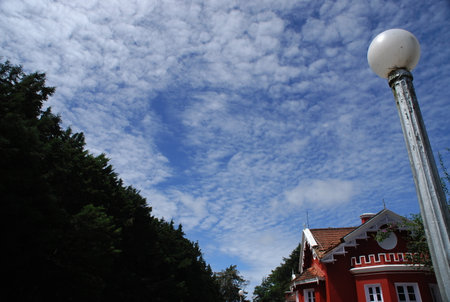 Lamppost and blue sky with white clouds in the backgroundの写真素材
