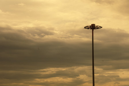 Lamp post with dramatic sky and cloud background, closeup of photoの写真素材