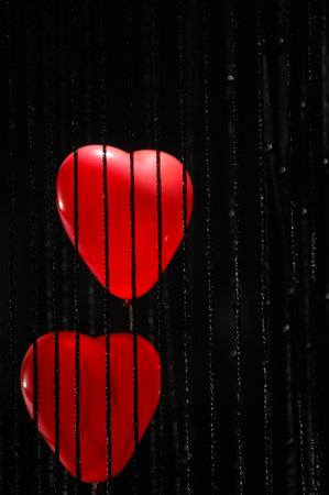 Valentines day background. Red hearts on a black background.の写真素材