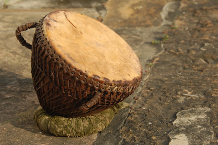 wooden djembe drum in a park, closeup of photo