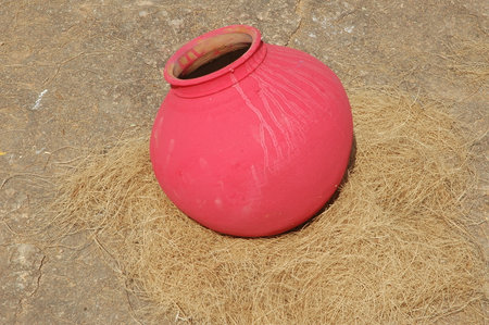 pink clay pot on the ground, closeup of photo.の写真素材