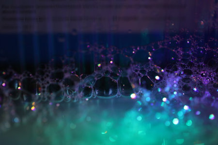 abstract background with bubbles and lights in blue, green and purpleの写真素材
